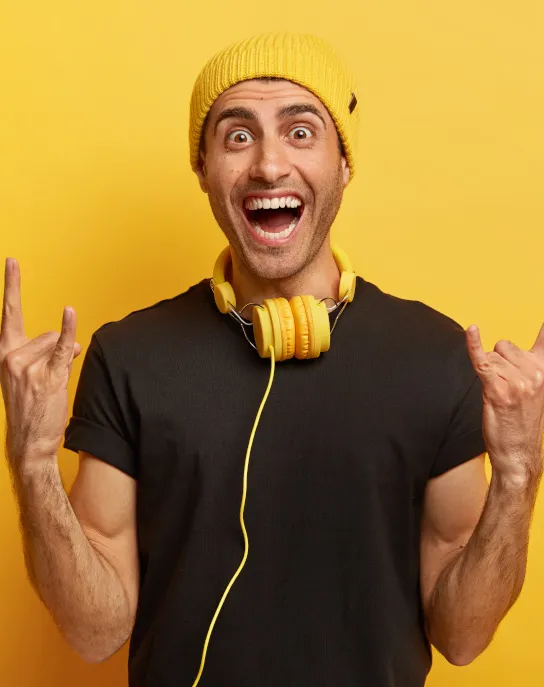 carefree joyful guy makes rock n roll gesture bri 24DLVB5