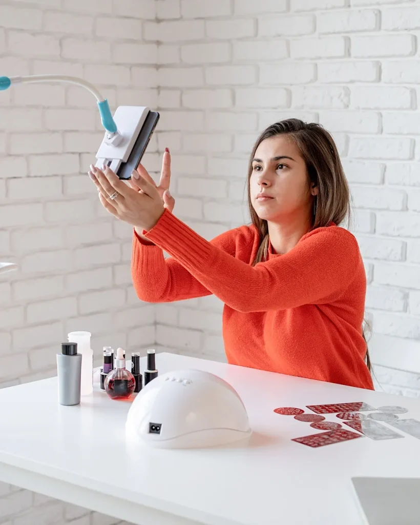 beautiful caucasian nail master influencer having video chat or making a blog