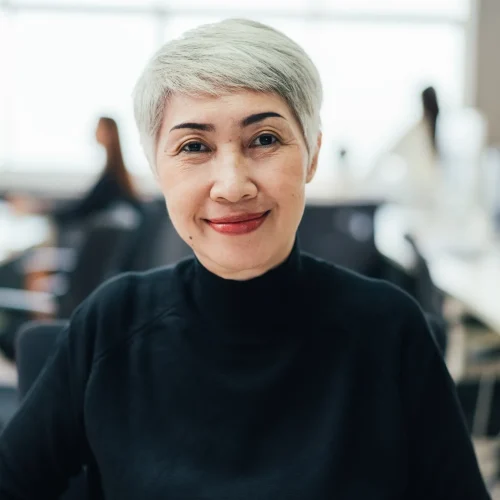 portrait of asian senior female manager at desk in the office