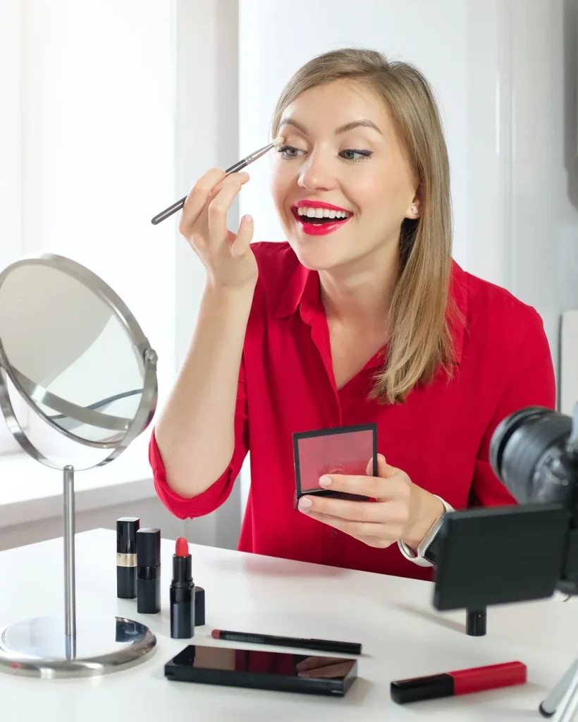 stylish young woman blogger recording make up video guide on beauty tips